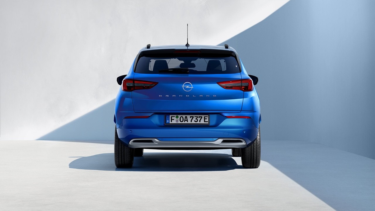 Rear view of a blue Opel Grandland Plug-in-Hybrid with black roof